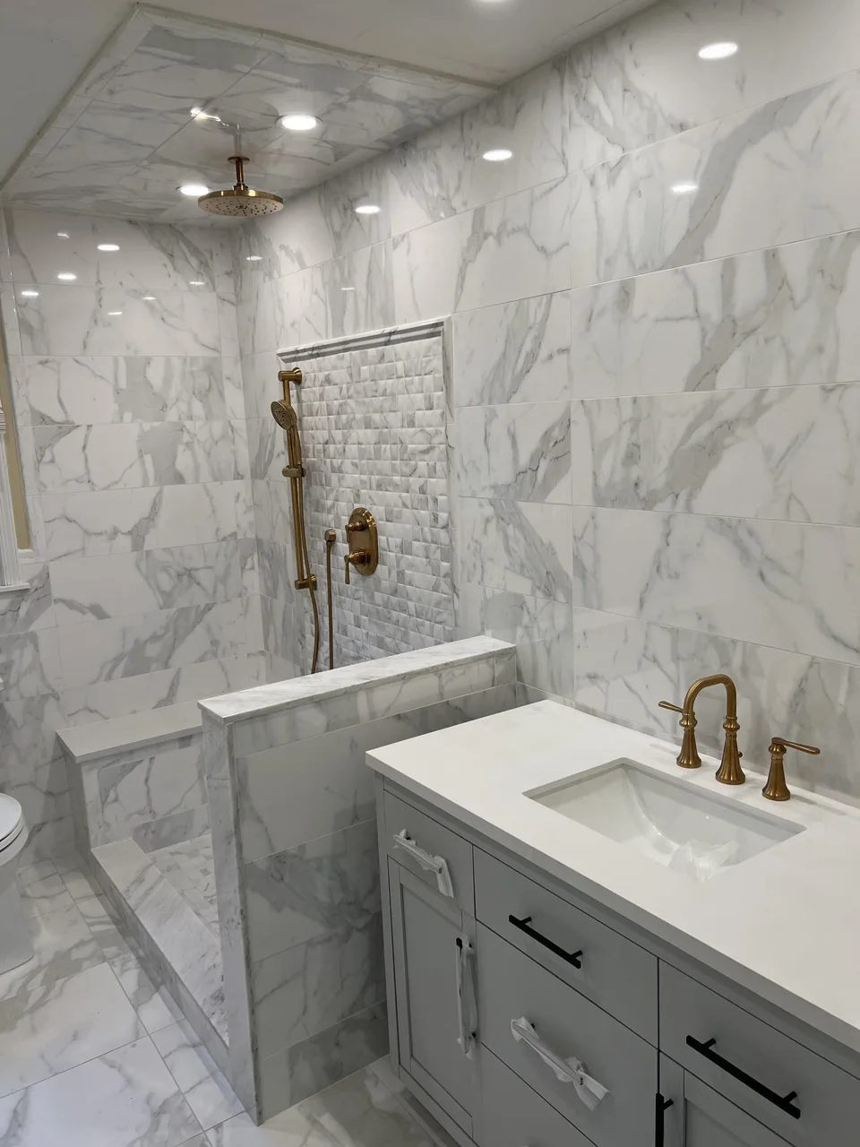 Marble-look bathroom tile, glass shower and vanity