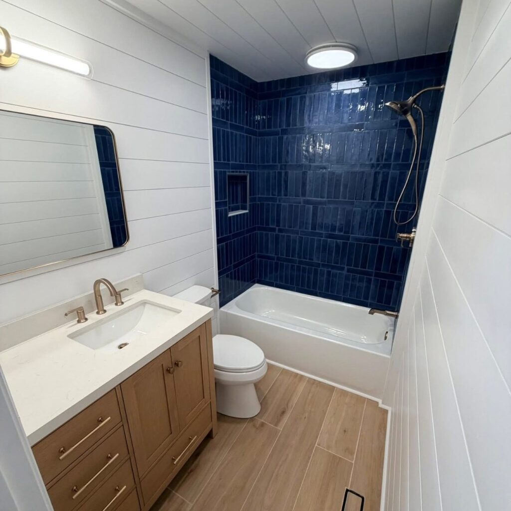 Navy tile tub surround with shiplap walls