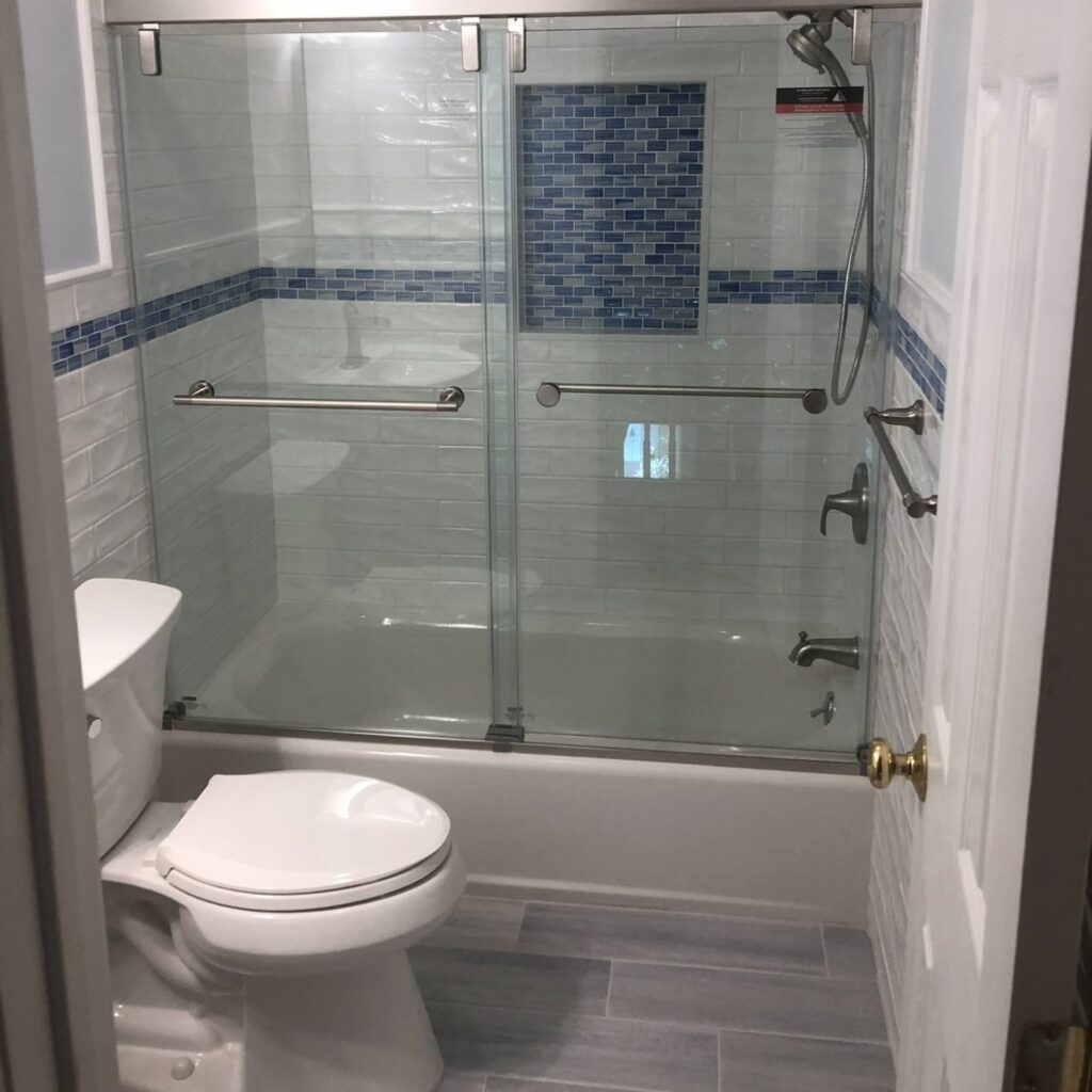 Tub and shower with blue glass mosaic accent