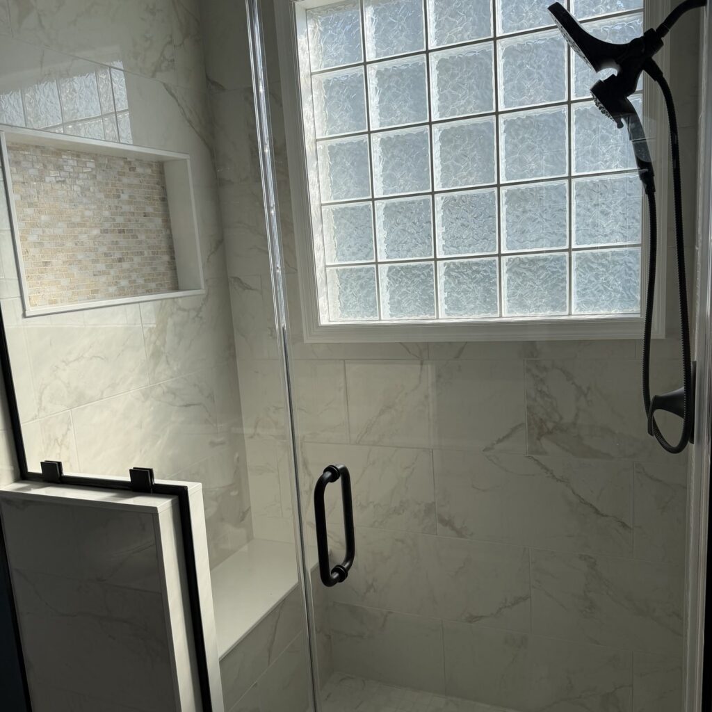 Marble tile shower with glass block window